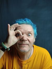 Portrait of man wearing mask against black background