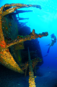 Scuba diver exploring sunken ship