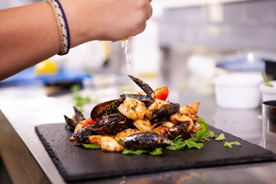 Cropped hand of person preparing food