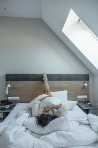 Woman in bed, feet elevated, feeling of zen and relaxation