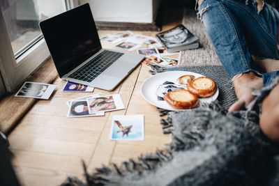 High angle view of woman using laptop on table at home