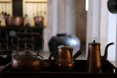 Close-up of tea kettles on table at home