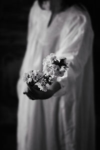 Rear view of woman holding flower bouquet