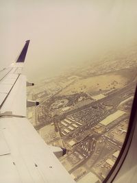 Aerial view of cityscape seen through airplane window