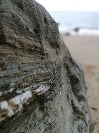 Close-up of water on rock against sky