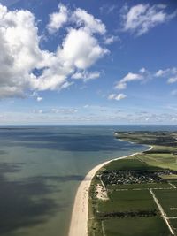 Scenic view of road by sea against sky