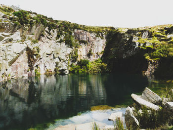 Scenic view of calm lake against mountain range