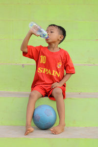 Portrait of boy playing with ball