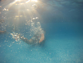 Low section of person swimming in sea