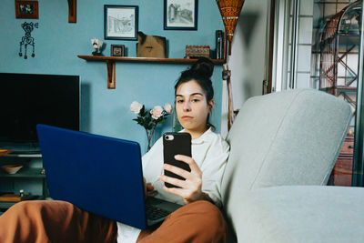 Young businesswoman laptop while sitting on sofa