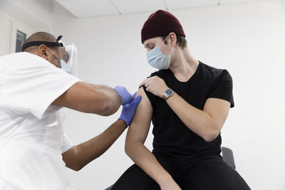 Young man getting vaccinated