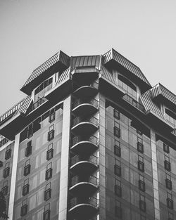 Low angle view of apartment building against clear sky