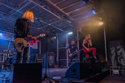 People playing guitar at music concert