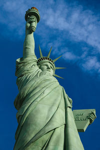 Low angle view of statue against blue sky