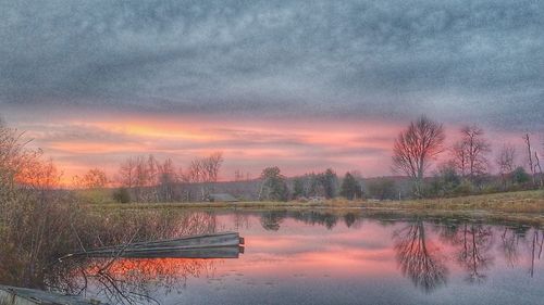 Reflection of trees in water against sky