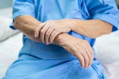 Midsection of man sitting on floor