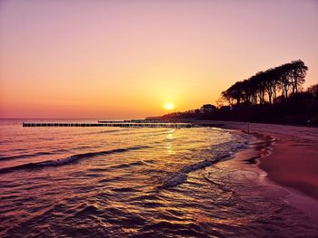 Scenic view of beach against sky during sunset