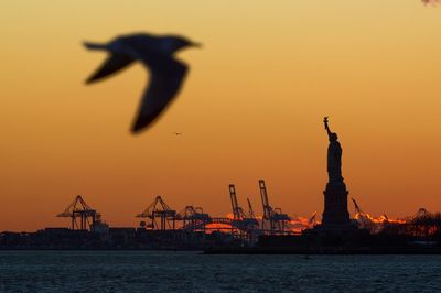 Silhouette of statue at sunset