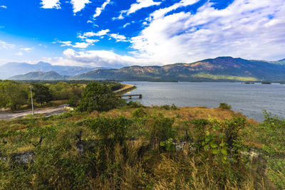 Scenic view of lake and mountains against sky