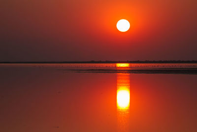 Scenic view of lake against romantic sky at sunset