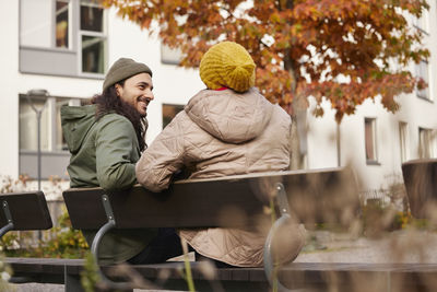 Man and woman sitting on bench