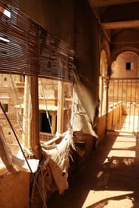 Damaged curtains and blinds of windows in historic building