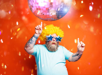 Man dancing under disco ball