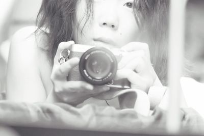 Close-up of female taking self portrait from digital camera