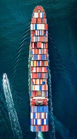 Aerial view of cargo containers on ship in sea