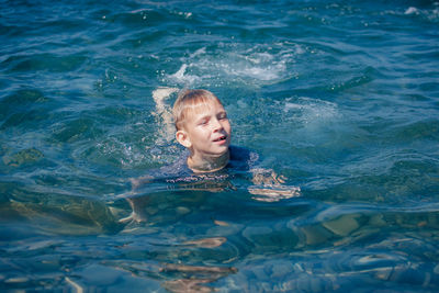 Portrait of young woman swimming in pool