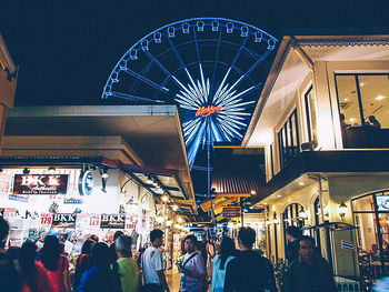 Low angle view of people in amusement park