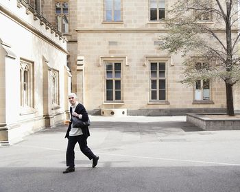 Full length of woman standing in front of building