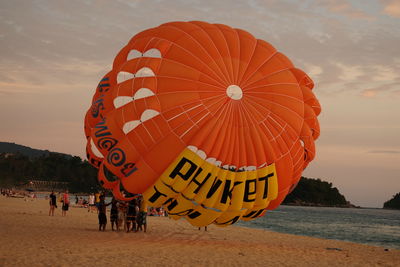 People on beach against sky