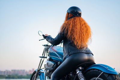 Rear view of woman riding bicycle