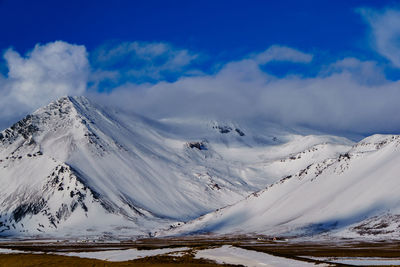 Scenic view of snowcapped mountains against sky