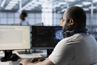 Side view of man working in office