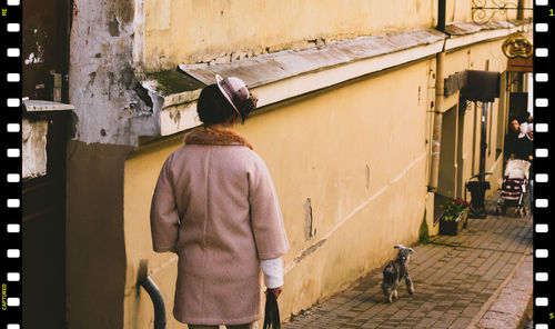 Rear view of men walking on footpath