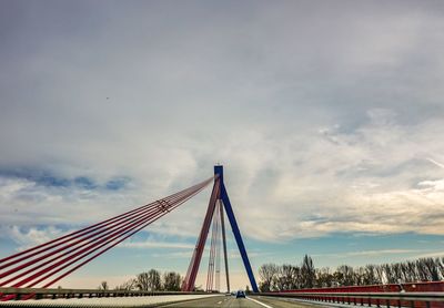 Low angle view of suspension bridge against sky