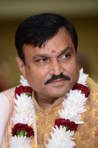 Close-up of bridegroom looking away at wedding 