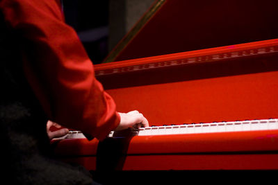 Midsection of man playing piano