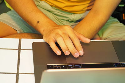 Midsection of man using mobile phone