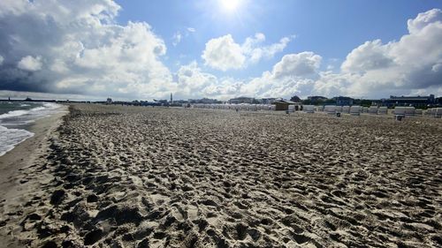 Scenic view of beach against sky on sunny day