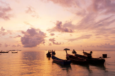 Scenic view of boat in sea during sunset