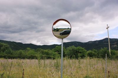 Street light on field against sky