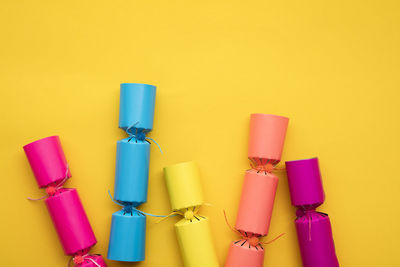 Close-up of multi colored toys against yellow background