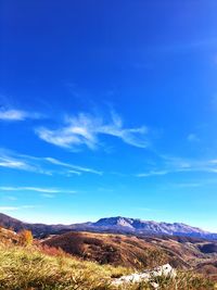 Scenic view of landscape against blue sky