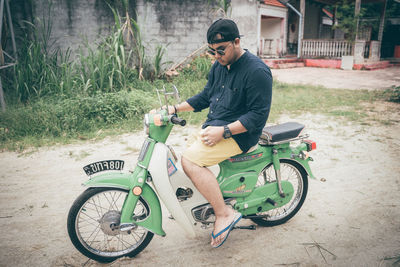 Side view of young man riding bicycle