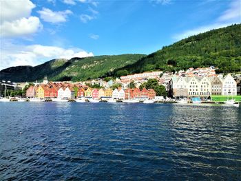 View of town on lake against cloudy sky