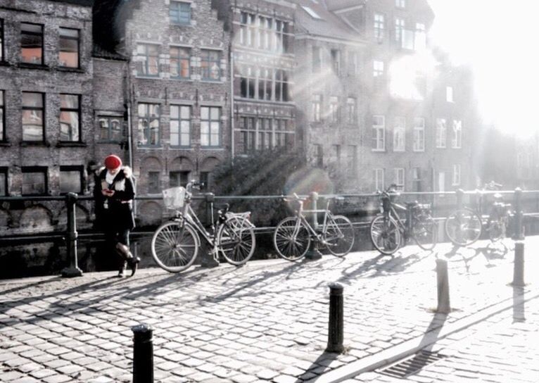 MAN RIDING BICYCLE ON CITY