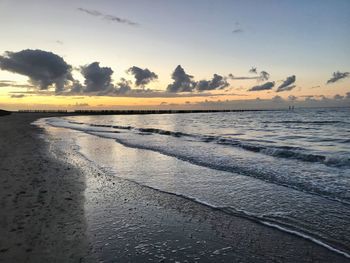 Scenic view of beach against sky during sunset